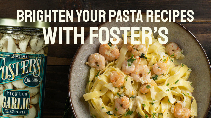Foster's pickled garlic jar with a pasta dish featuring shrimp and herbs on a wooden surface.